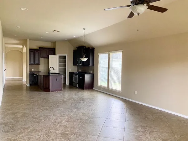 a open kitchen with cabinets and stainless steel appliances