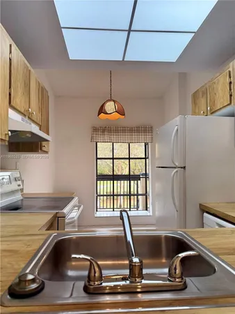 a view of a kitchen with kitchen island a counter tops and a window
