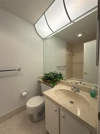 a bathroom with a sink a toilet and mirror