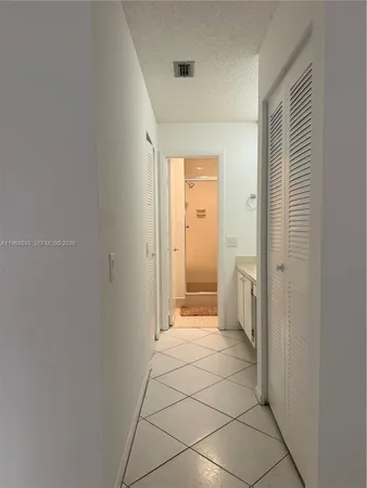 a spacious bathroom with a glass door shower and a sink