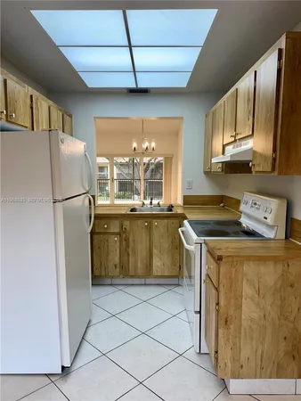 a kitchen with stainless steel appliances granite countertop a refrigerator a sink and a stove