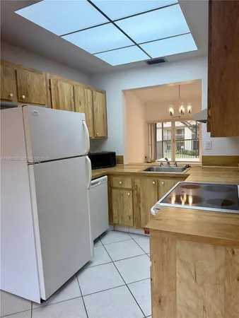 a kitchen with a refrigerator a sink and a stove