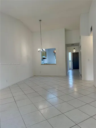 a view of a hallway with a chandelier