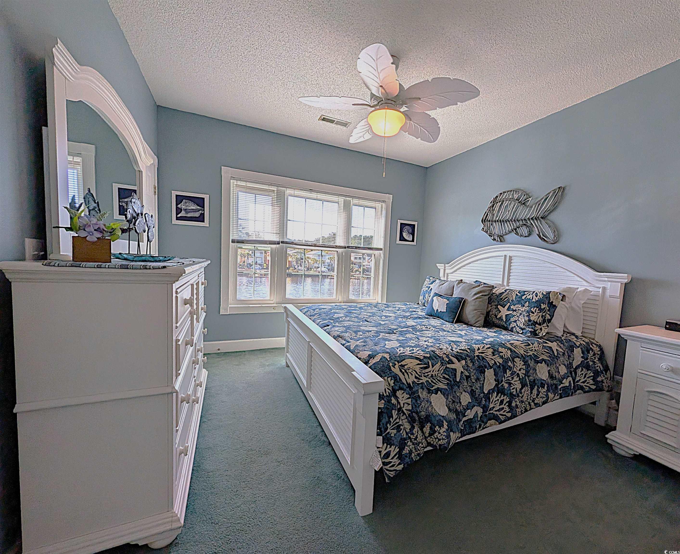 1512 Lanterns Rest Road, Unit 201 Myrtle Beach, SC 29579 - Photo 11 of 23 Carpeted bedroom with a textured ceiling and a ceiling fan