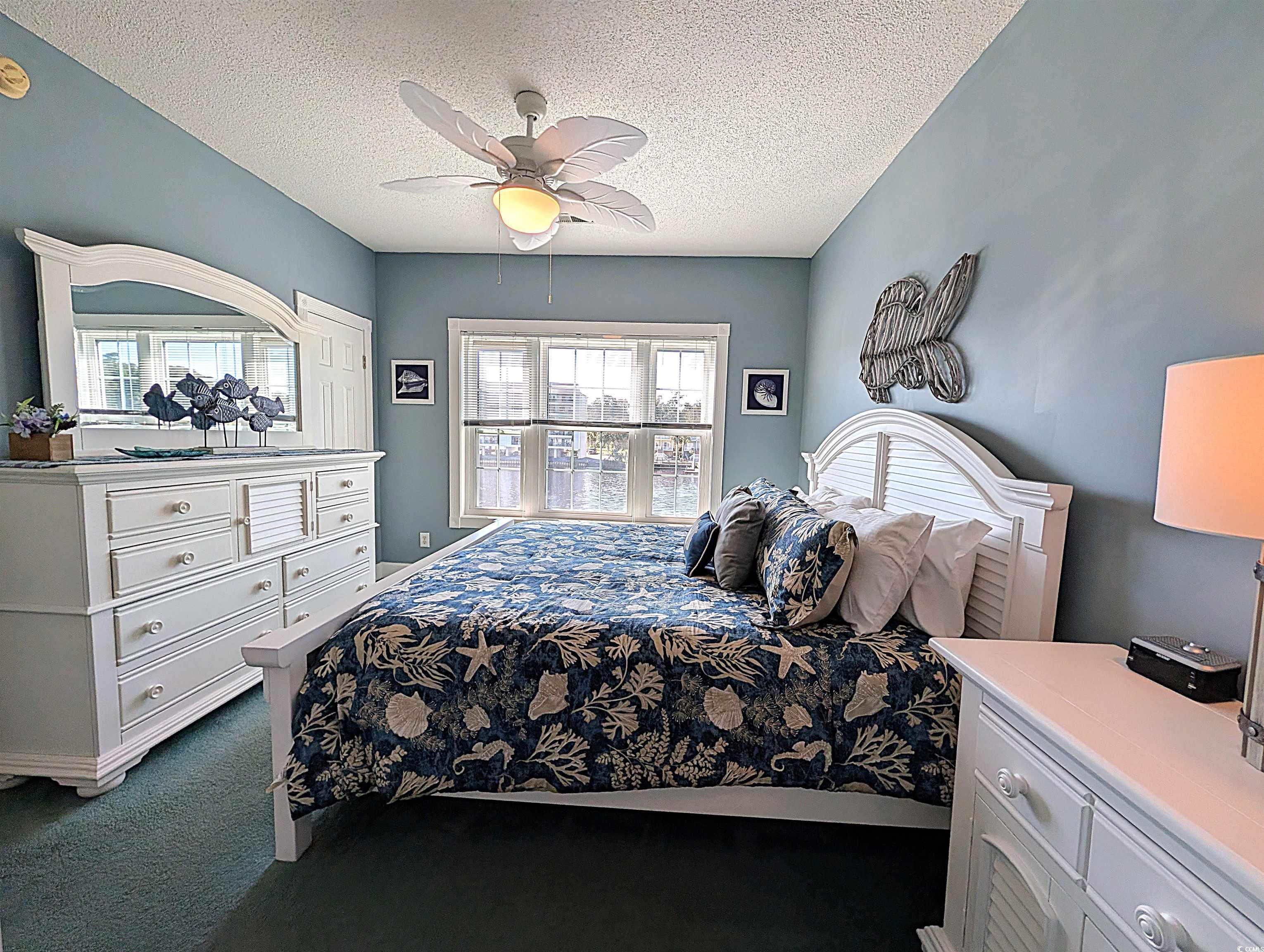 1512 Lanterns Rest Road, Unit 201 Myrtle Beach, SC 29579 - Photo 12 of 23 Bedroom with a textured ceiling, dark carpet, and a ceiling fan