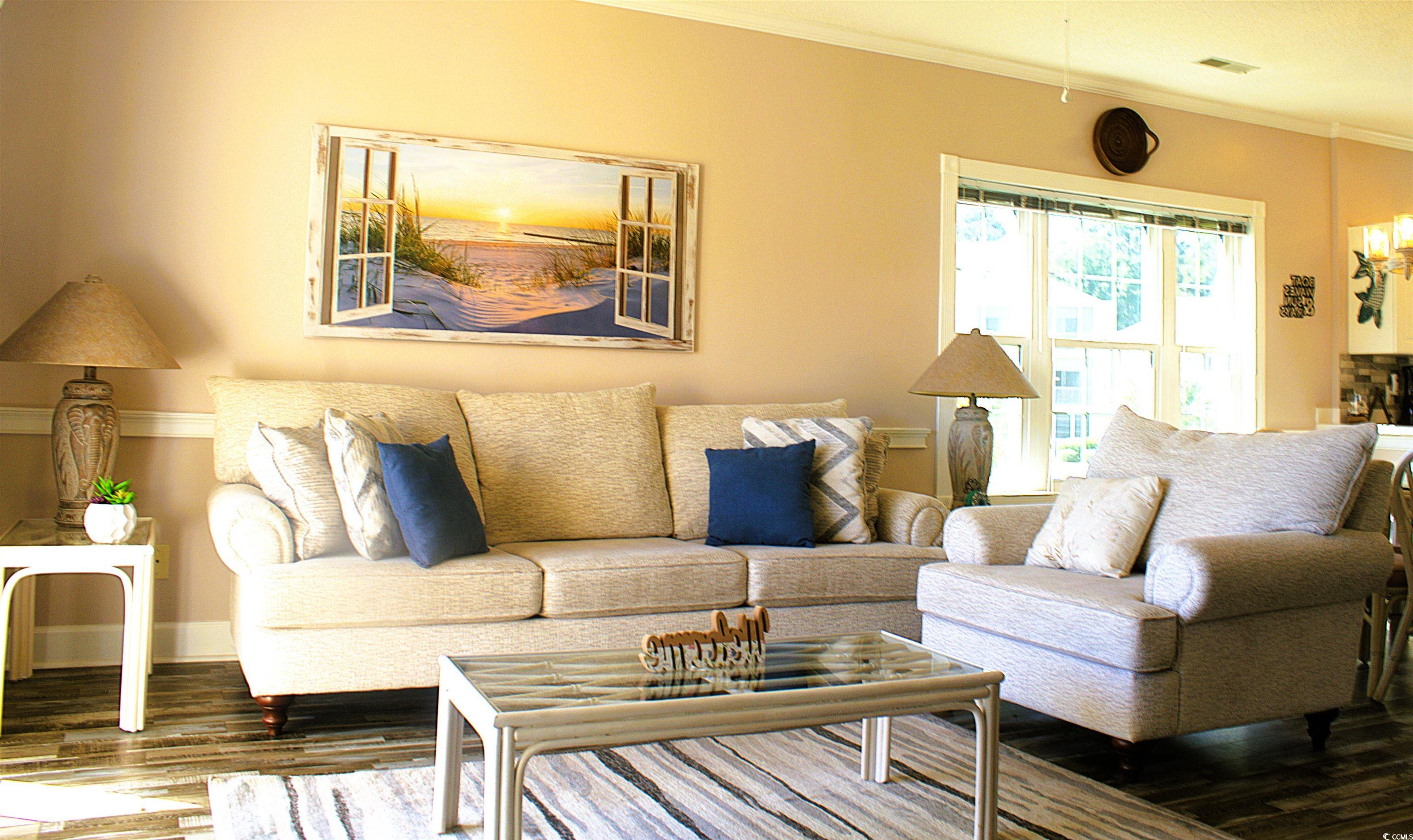 1512 Lanterns Rest Road, Unit 201 Myrtle Beach, SC 29579 - Photo 7 of 23 Living area featuring crown molding and wood finished floors