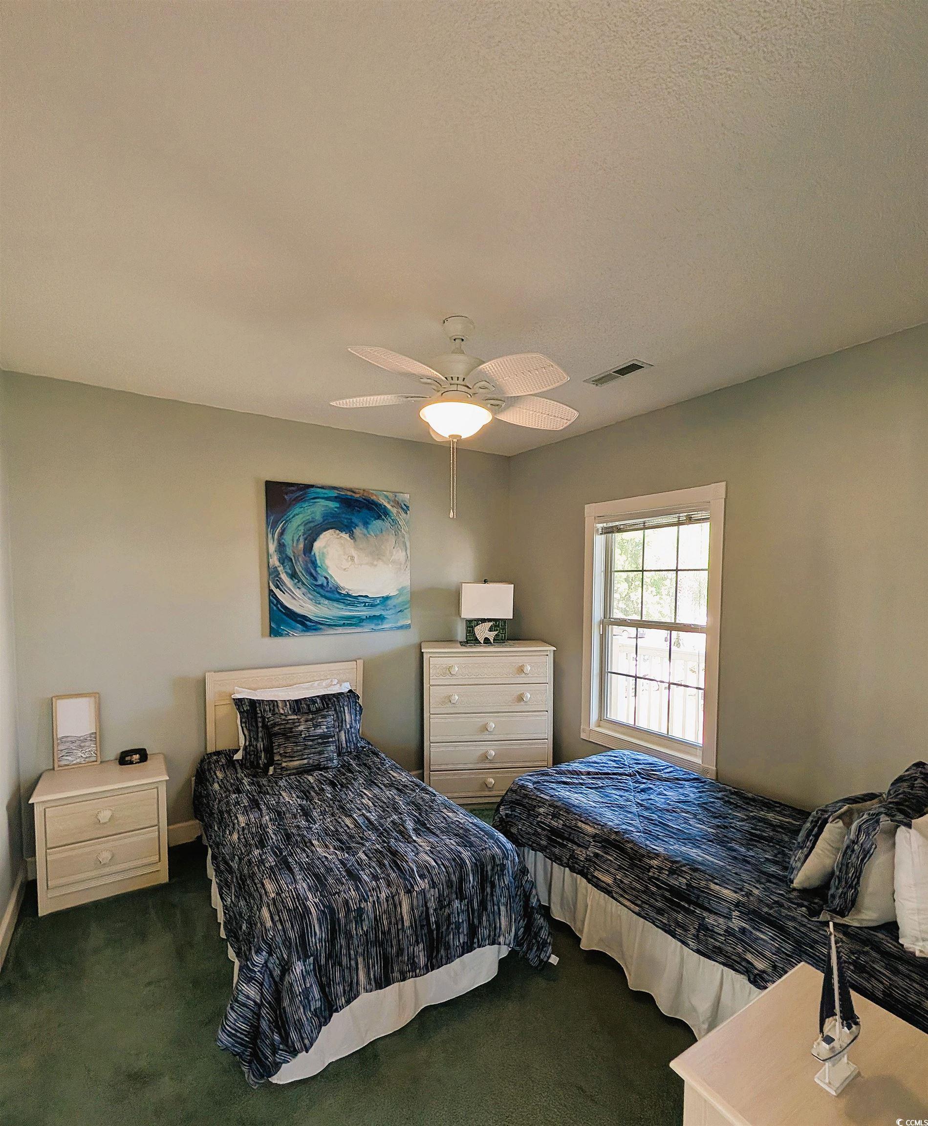 1512 Lanterns Rest Road, Unit 201 Myrtle Beach, SC 29579 - Photo 9 of 23 Bedroom featuring dark colored carpet, ceiling fan, and a textured ceiling