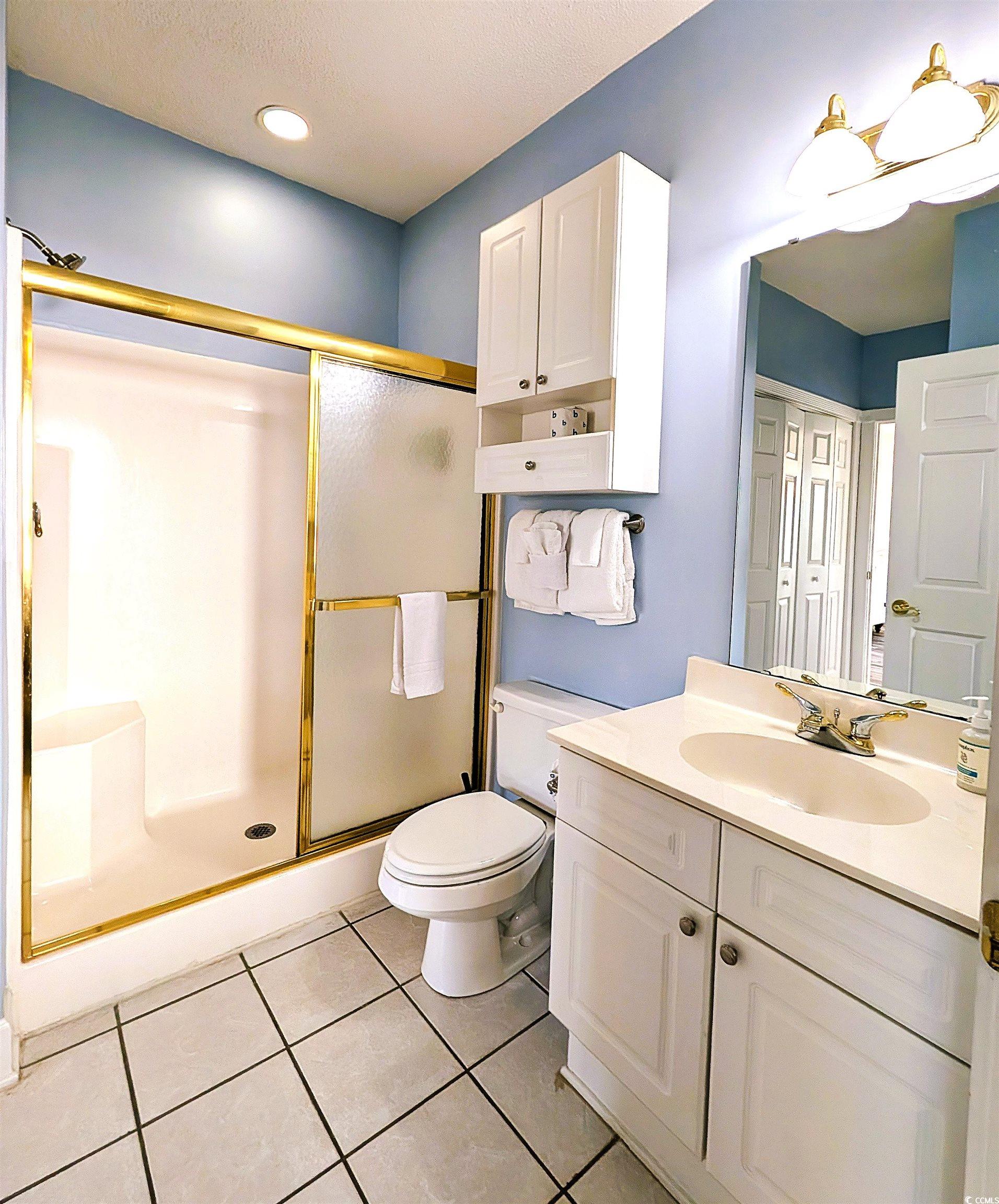 1512 Lanterns Rest Road, Unit 201 Myrtle Beach, SC 29579 - Photo 10 of 23 Bathroom featuring vanity, light tile patterned floors, and a shower stall