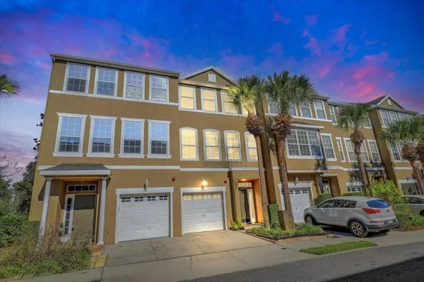 a front view of a residential apartment building with a yard