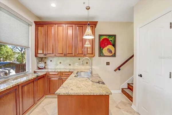 a kitchen with a window a sink and a refrigerator
