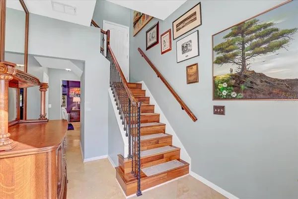 a view of entryway and hall with wooden floor