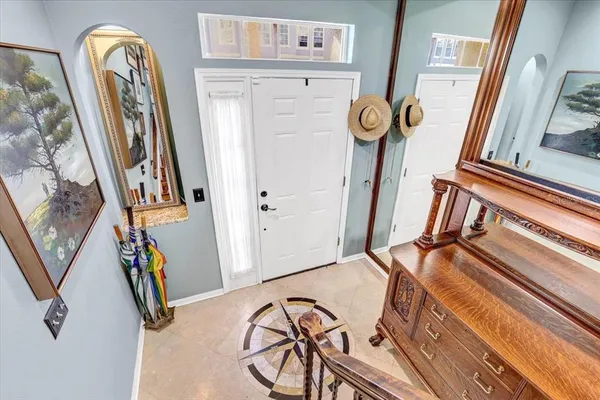 a view of front door with hallway and stairs
