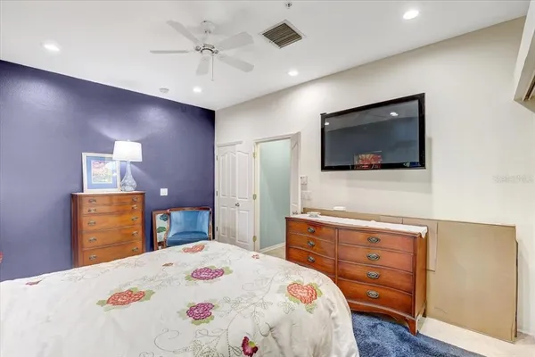 a bedroom with a bed and a flat screen tv