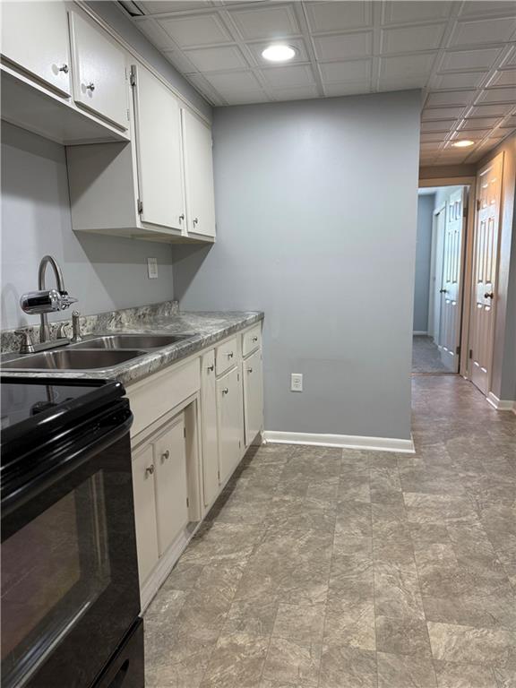 19 Studa Street, Unit 1 Burgettstown, PA 15021 - Photo 4 of 13 a kitchen with granite countertop a stove sink and cabinets
