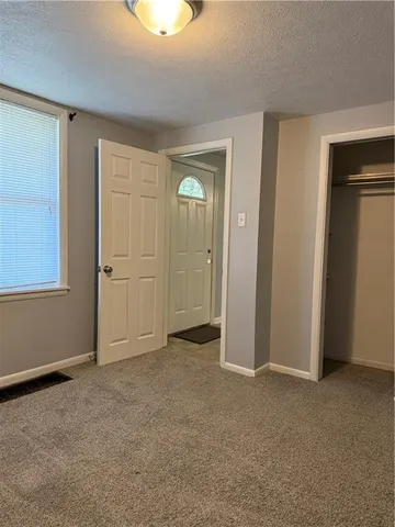 an empty room with closet area