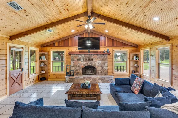 a living room with furniture a flat screen tv and a fireplace