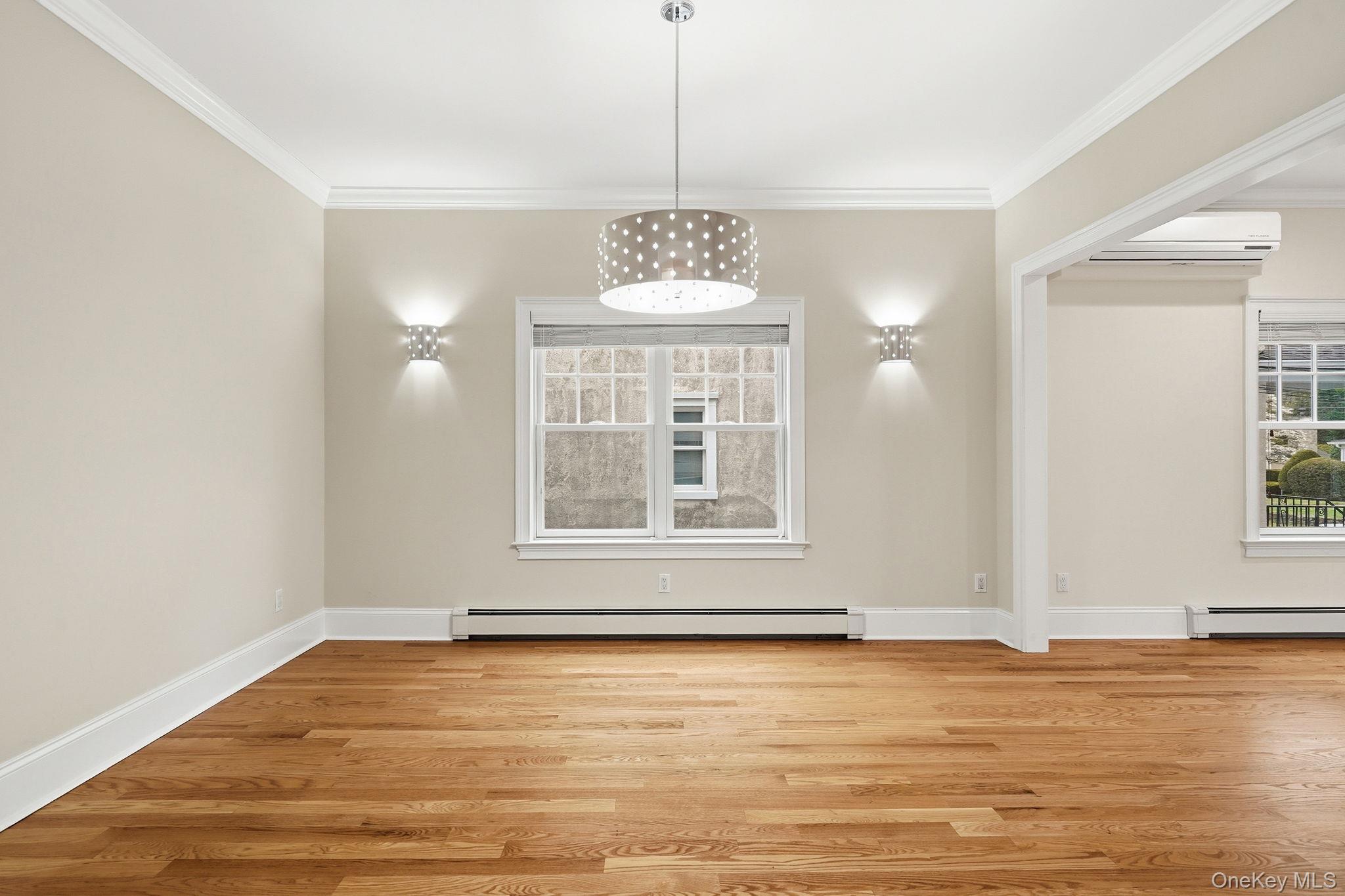 228 Central Avenue Rye, NY 10580 - Photo 6 of 24 a view of an empty room with window and wooden floor