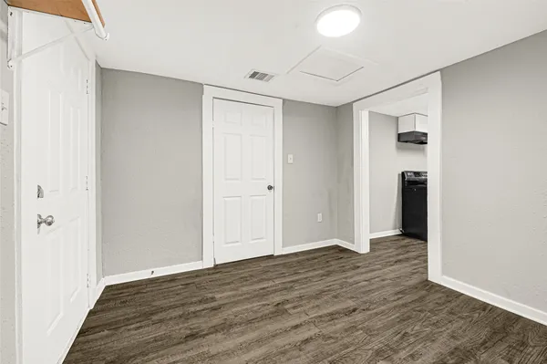 an empty room with wooden floor and closet