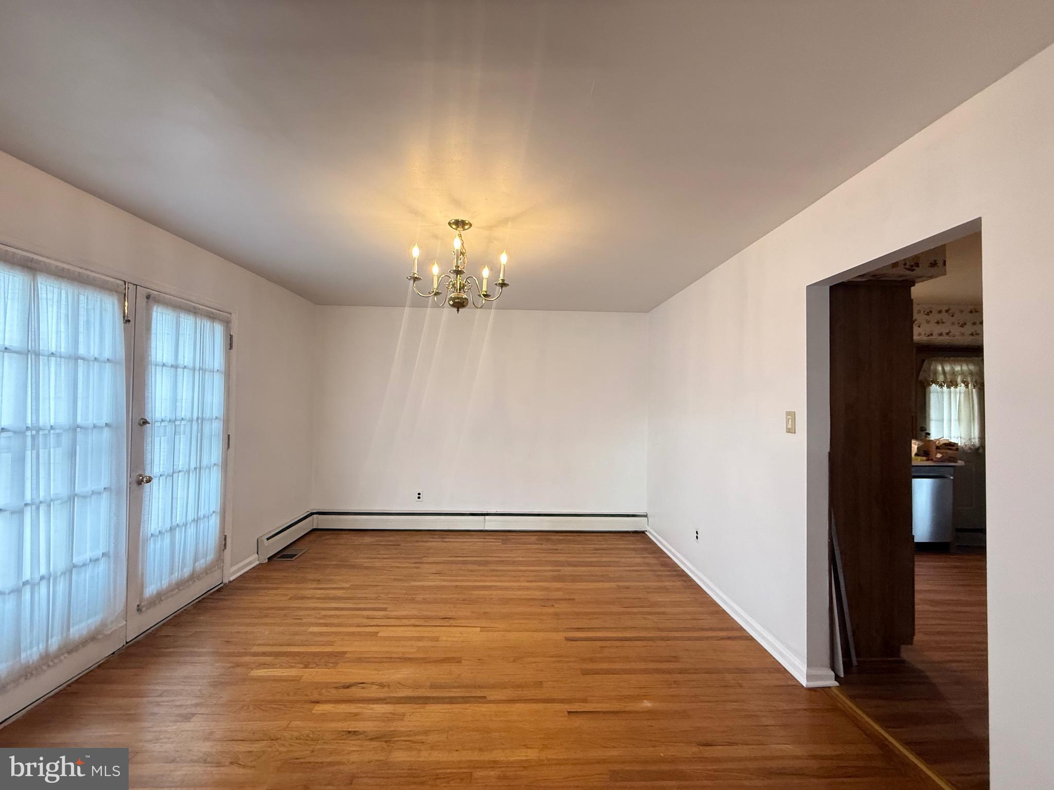 338 Rees Drive King of Prussia, PA 19406 - Photo 11 of 35 wooden floor in an empty room with a window