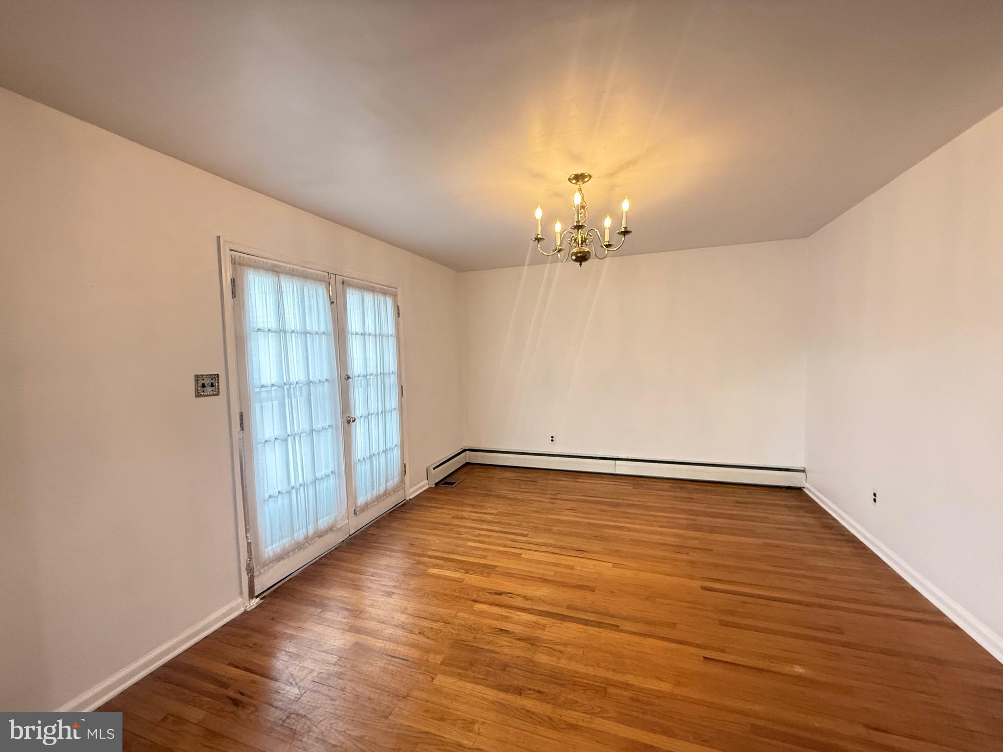 338 Rees Drive King of Prussia, PA 19406 - Photo 12 of 35 wooden floor in an empty room with a window