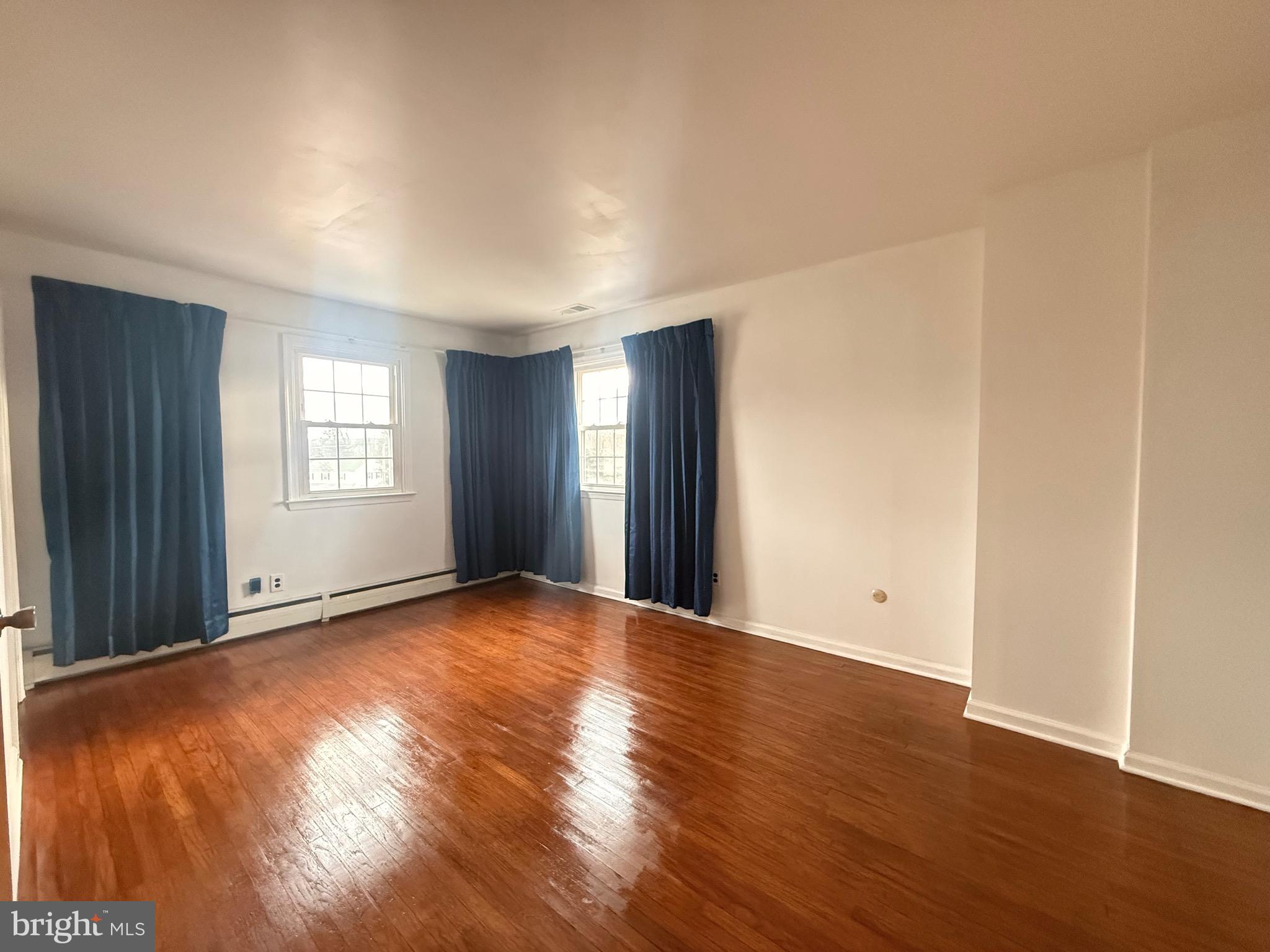338 Rees Drive King of Prussia, PA 19406 - Photo 14 of 35 an empty room with wooden floor and windows