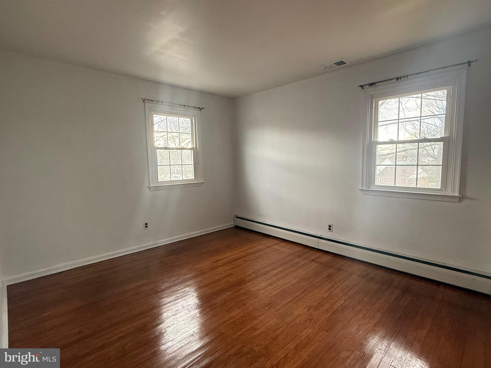 338 Rees Drive King of Prussia, PA 19406 - Photo 15 of 35 an empty room with wooden floor and windows