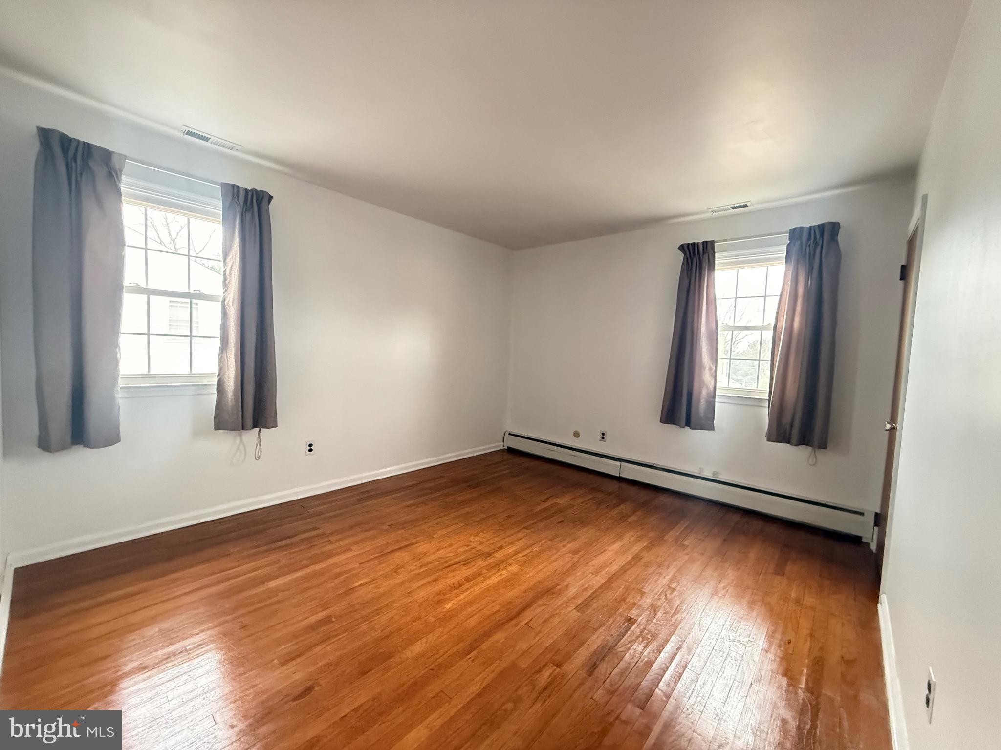 338 Rees Drive King of Prussia, PA 19406 - Photo 16 of 35 an empty room with wooden floor and windows