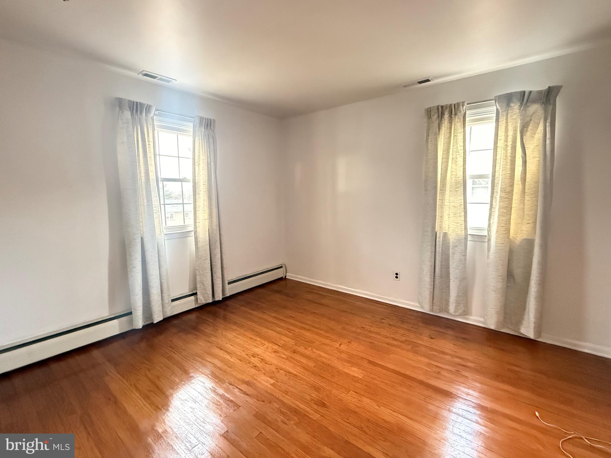338 Rees Drive King of Prussia, PA 19406 - Photo 18 of 35 an empty room with wooden floor and windows