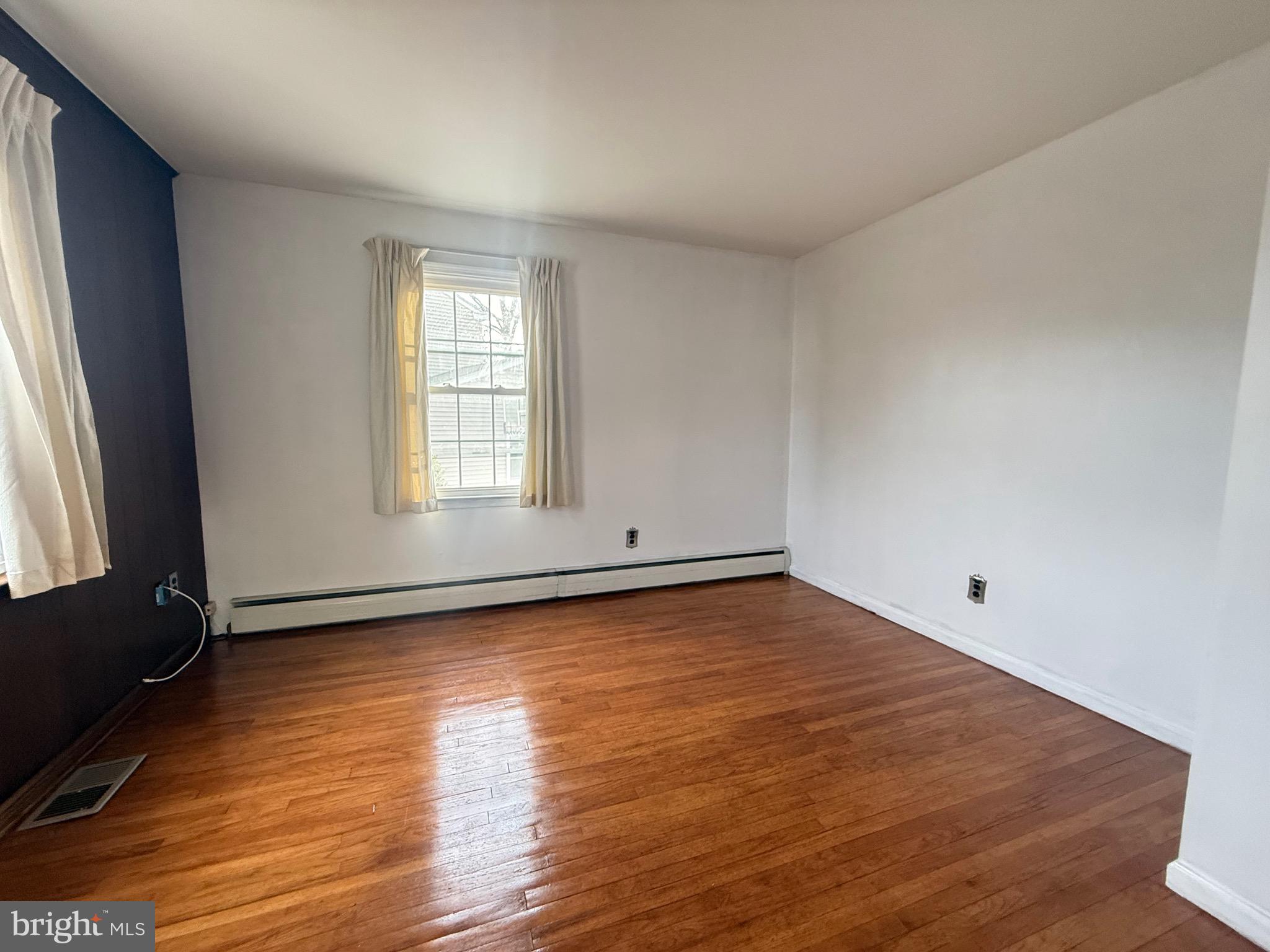 338 Rees Drive King of Prussia, PA 19406 - Photo 21 of 35 an empty room with wooden floor and windows