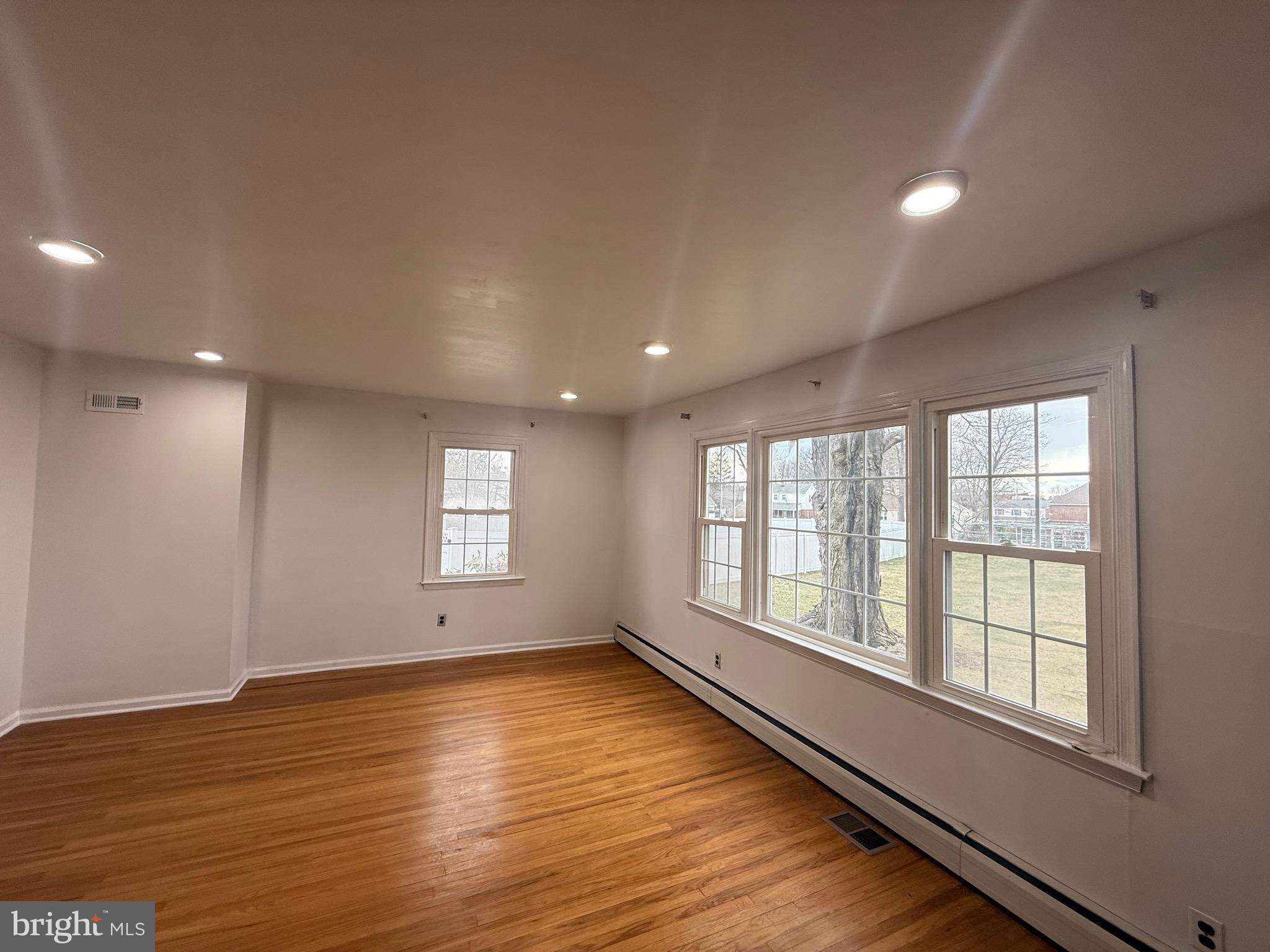 338 Rees Drive King of Prussia, PA 19406 - Photo 22 of 35 an empty room with wooden floor and windows