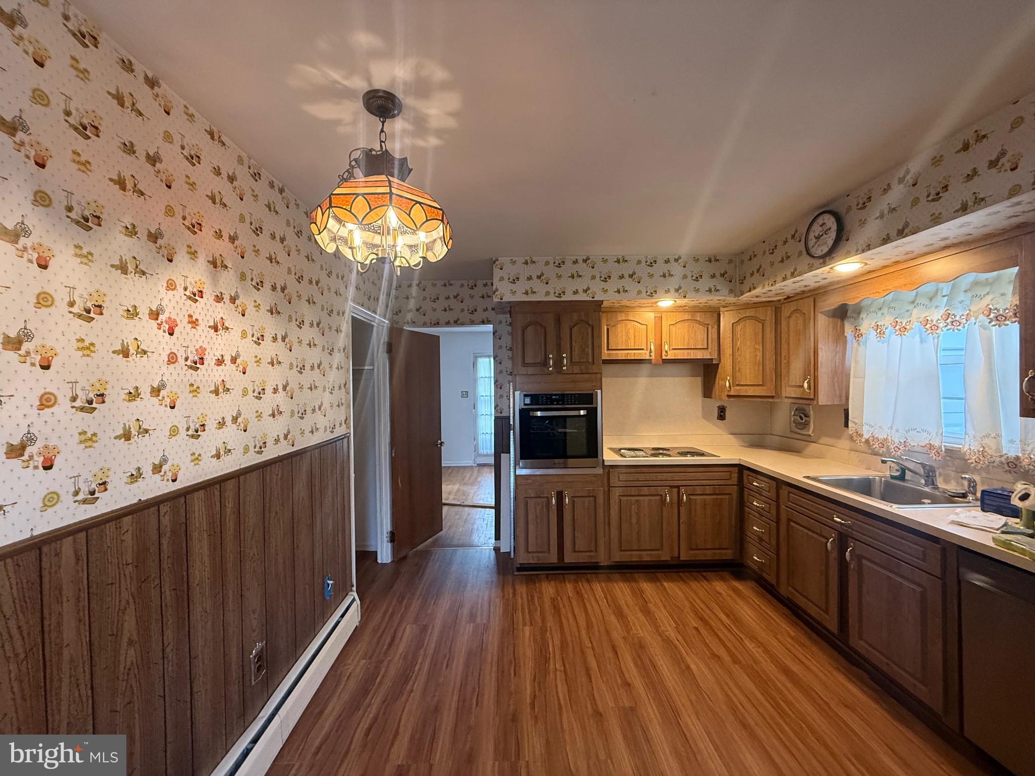 338 Rees Drive King of Prussia, PA 19406 - Photo 23 of 35 a kitchen with sink cabinets and wooden floor