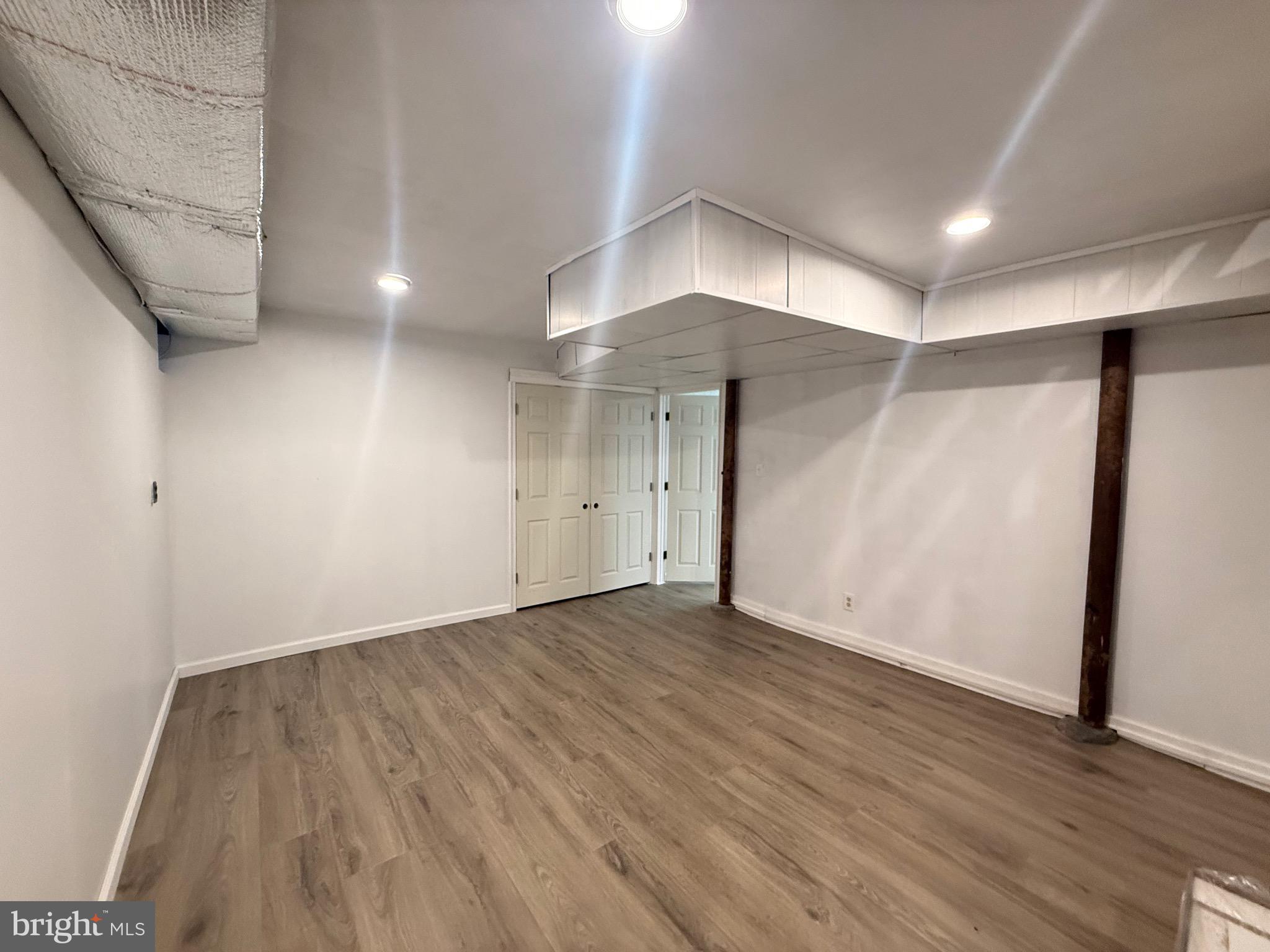 338 Rees Drive King of Prussia, PA 19406 - Photo 24 of 35 an empty room with wooden floor and chandelier
