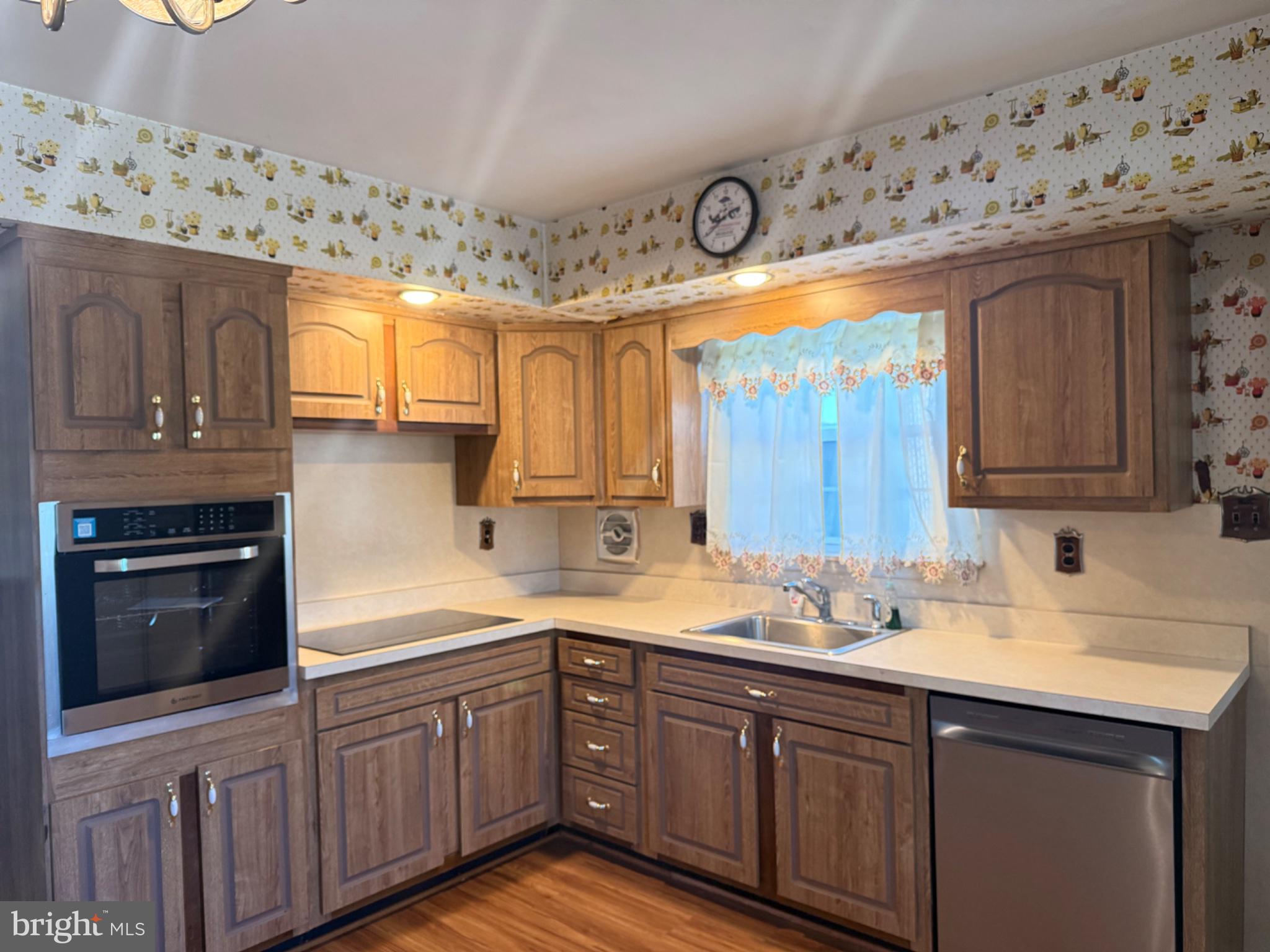 338 Rees Drive King of Prussia, PA 19406 - Photo 30 of 35 a kitchen with stainless steel appliances a sink a stove cabinets and wooden floor