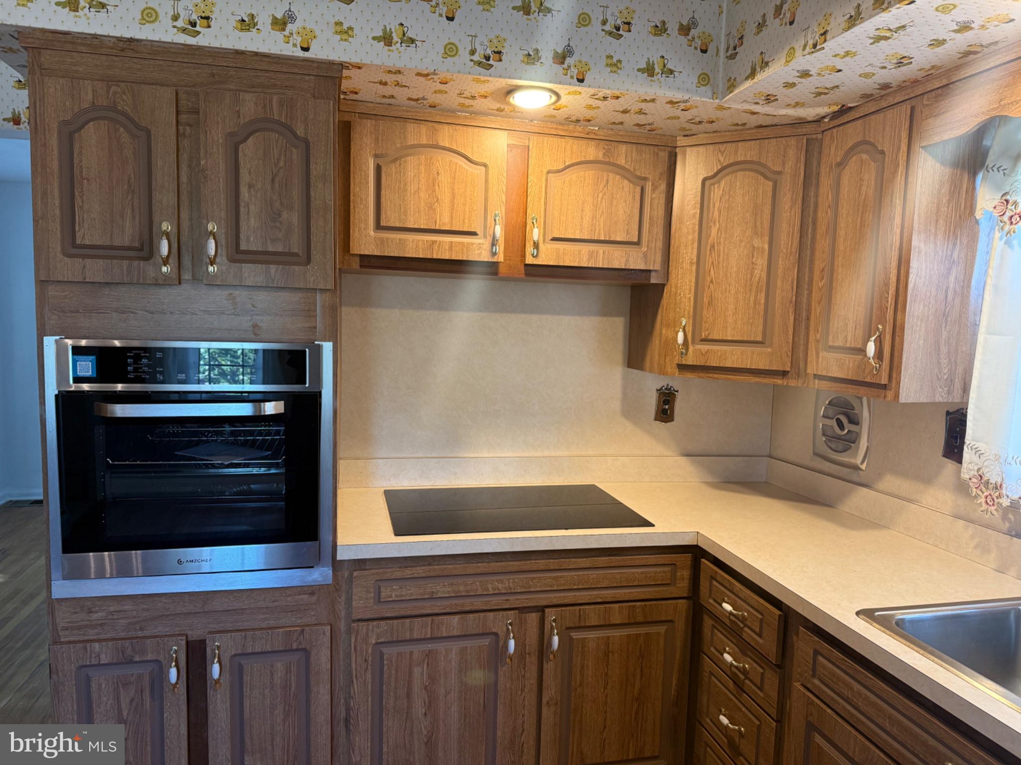338 Rees Drive King of Prussia, PA 19406 - Photo 31 of 35 a kitchen with stainless steel appliances granite countertop a sink a stove and cabinets