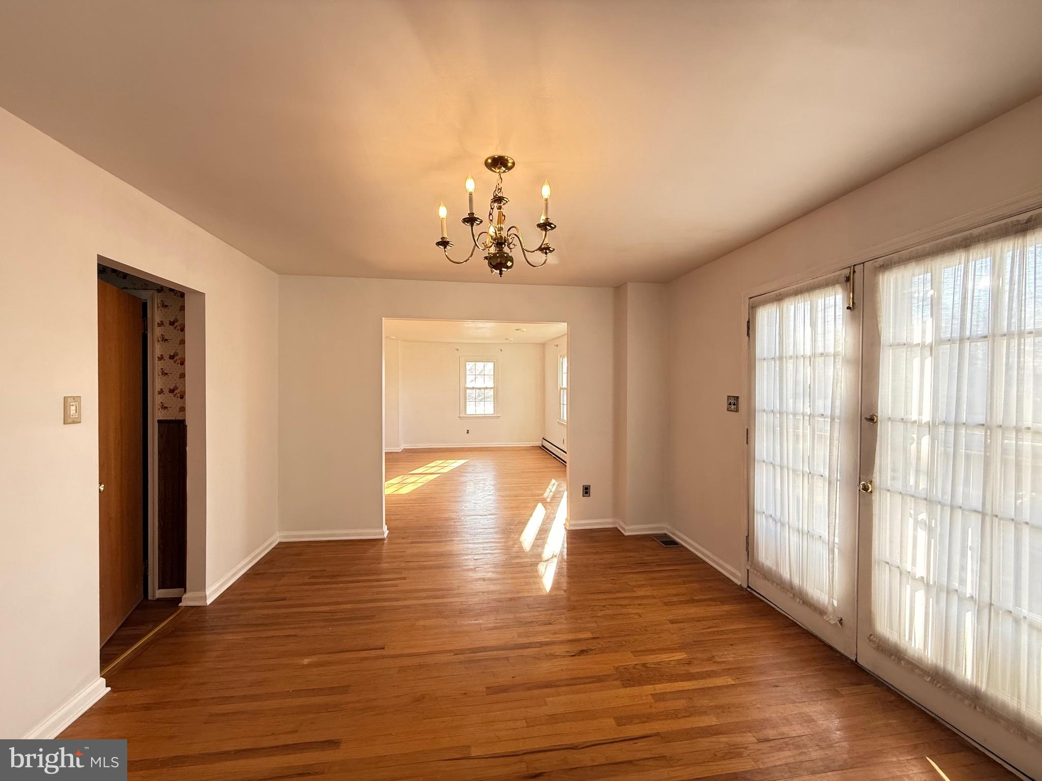 338 Rees Drive King of Prussia, PA 19406 - Photo 6 of 35 a view of an empty room with wooden floor and a window