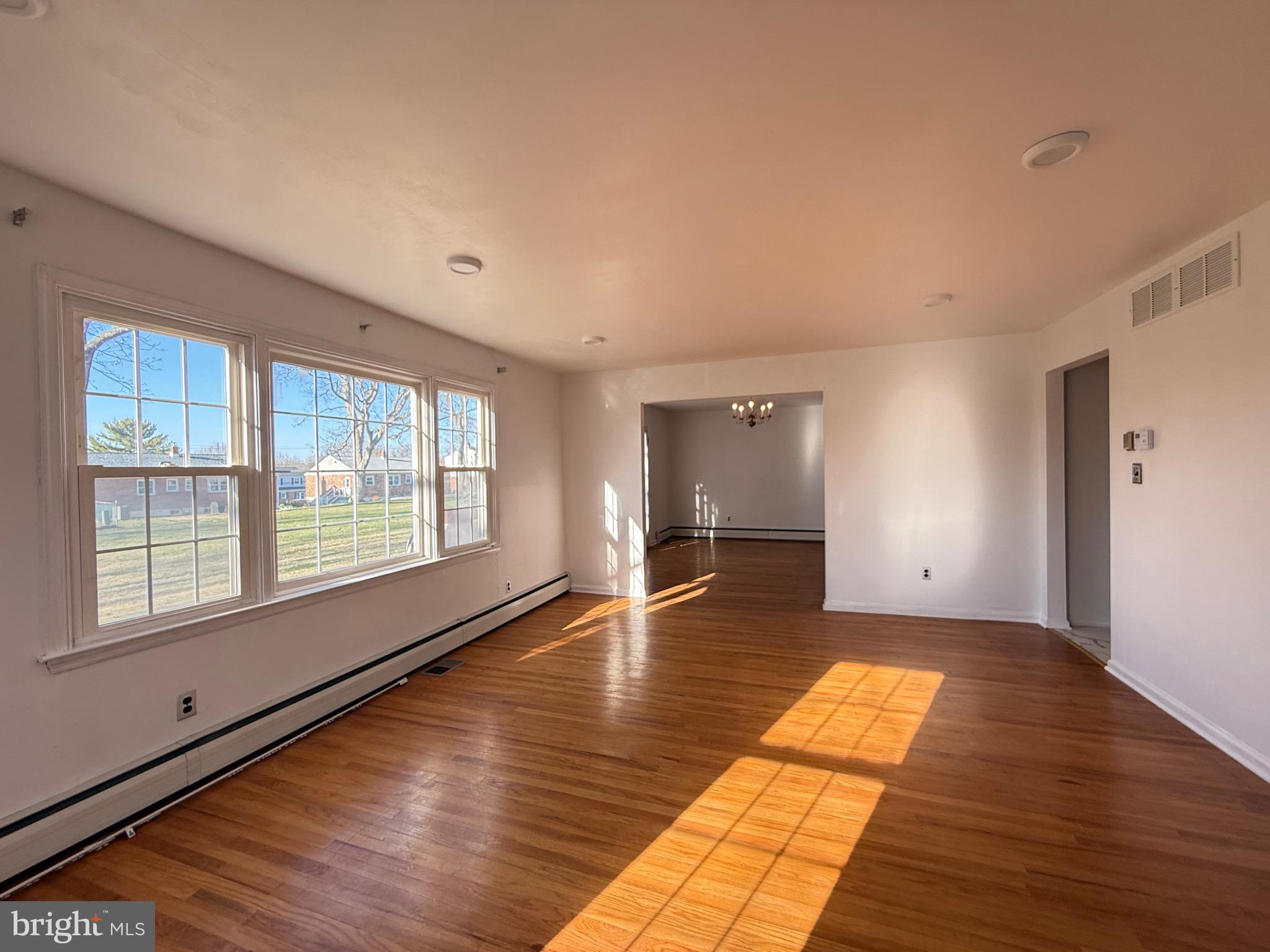 338 Rees Drive King of Prussia, PA 19406 - Photo 7 of 35 a view of empty room with wooden floor and fan