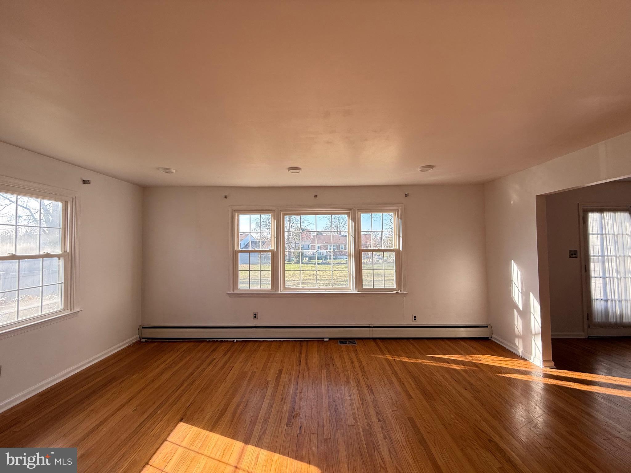 338 Rees Drive King of Prussia, PA 19406 - Photo 10 of 35 an empty room with wooden floor and windows
