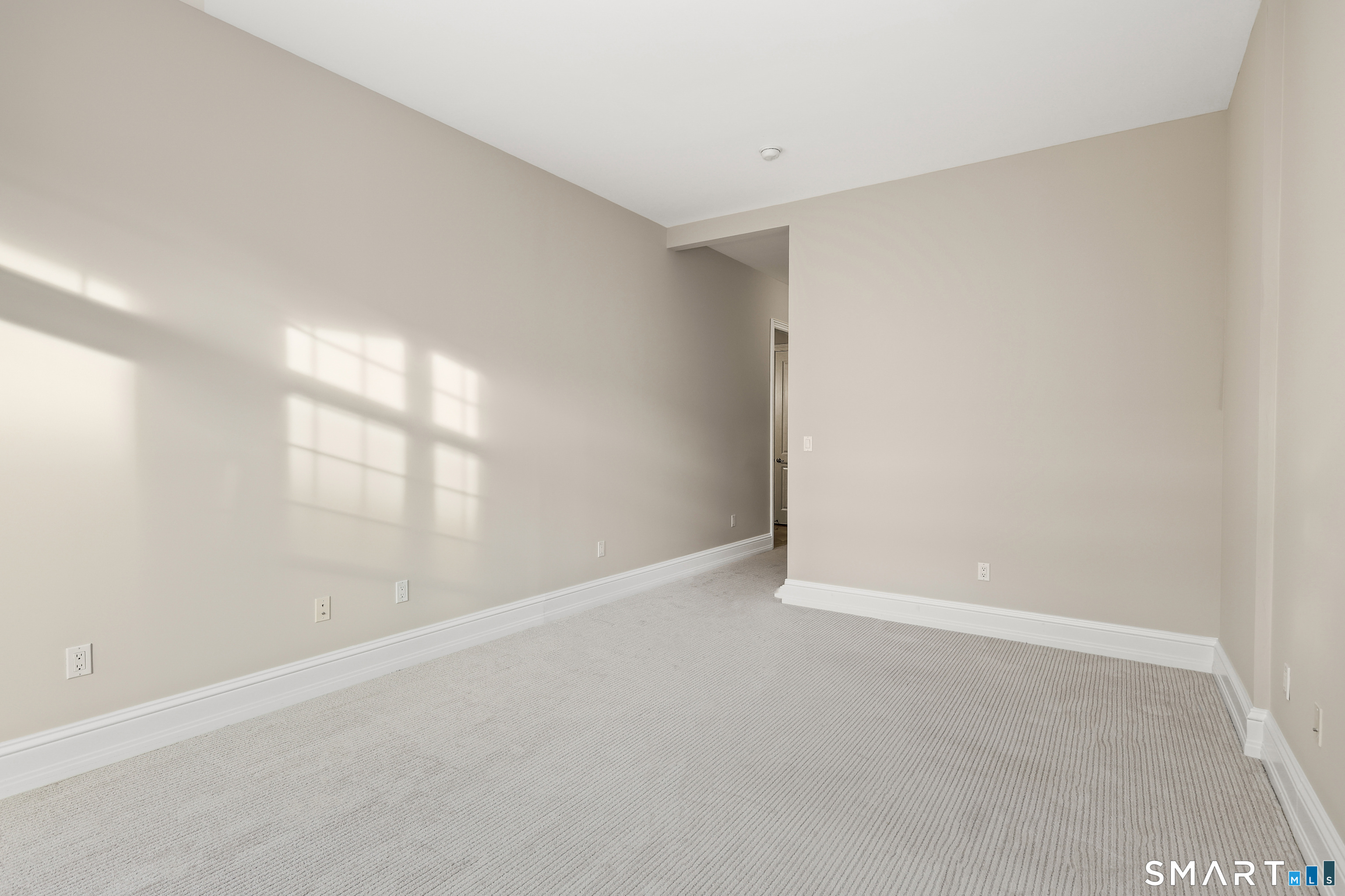 50 Stone Ridge Way, Unit 2A Fairfield, CT 06824 - Photo 18 of 36 a view of an empty room with a window