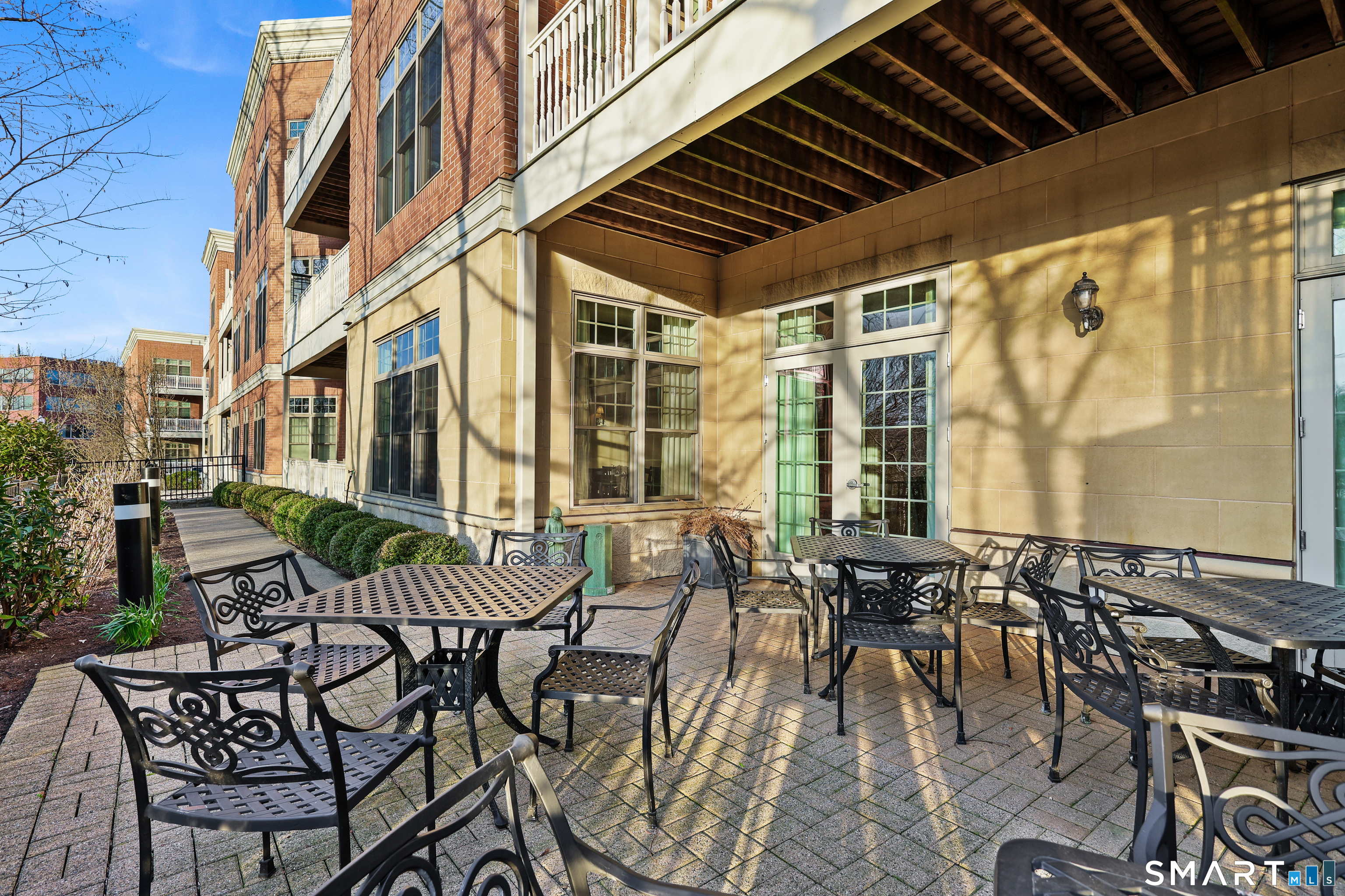 50 Stone Ridge Way, Unit 2A Fairfield, CT 06824 - Photo 30 of 36 a view of a patio with table and chairs and potted plants