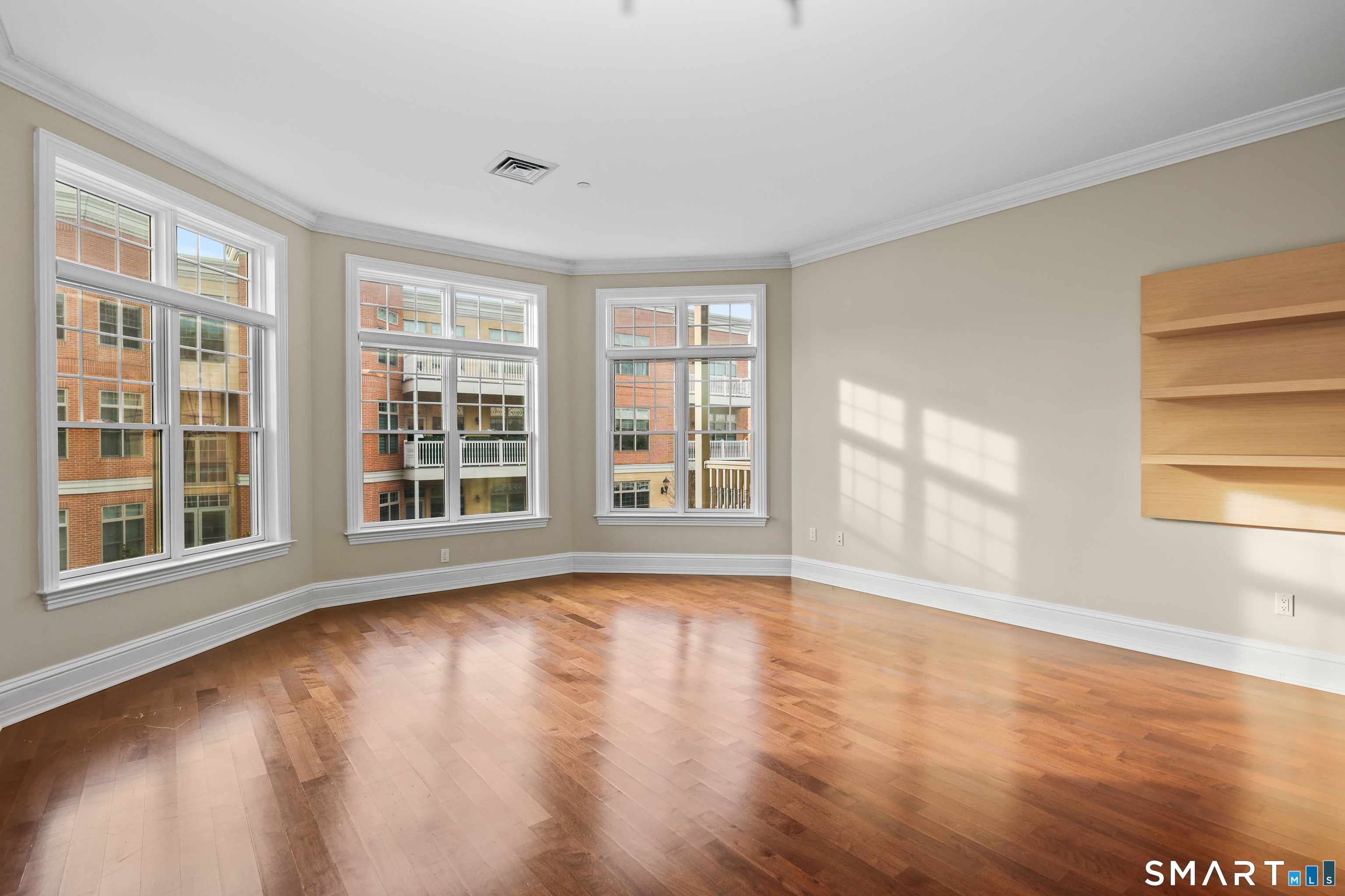 50 Stone Ridge Way, Unit 2A Fairfield, CT 06824 - Photo 3 of 36 a view of an empty room with wooden floor and a window