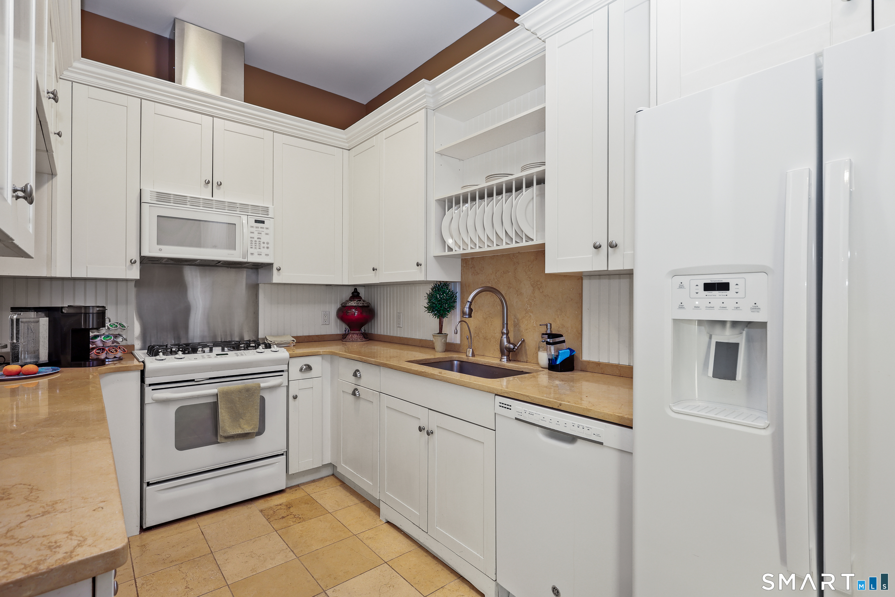 50 Stone Ridge Way, Unit 2A Fairfield, CT 06824 - Photo 31 of 36 a kitchen with stainless steel appliances granite countertop a sink and cabinets