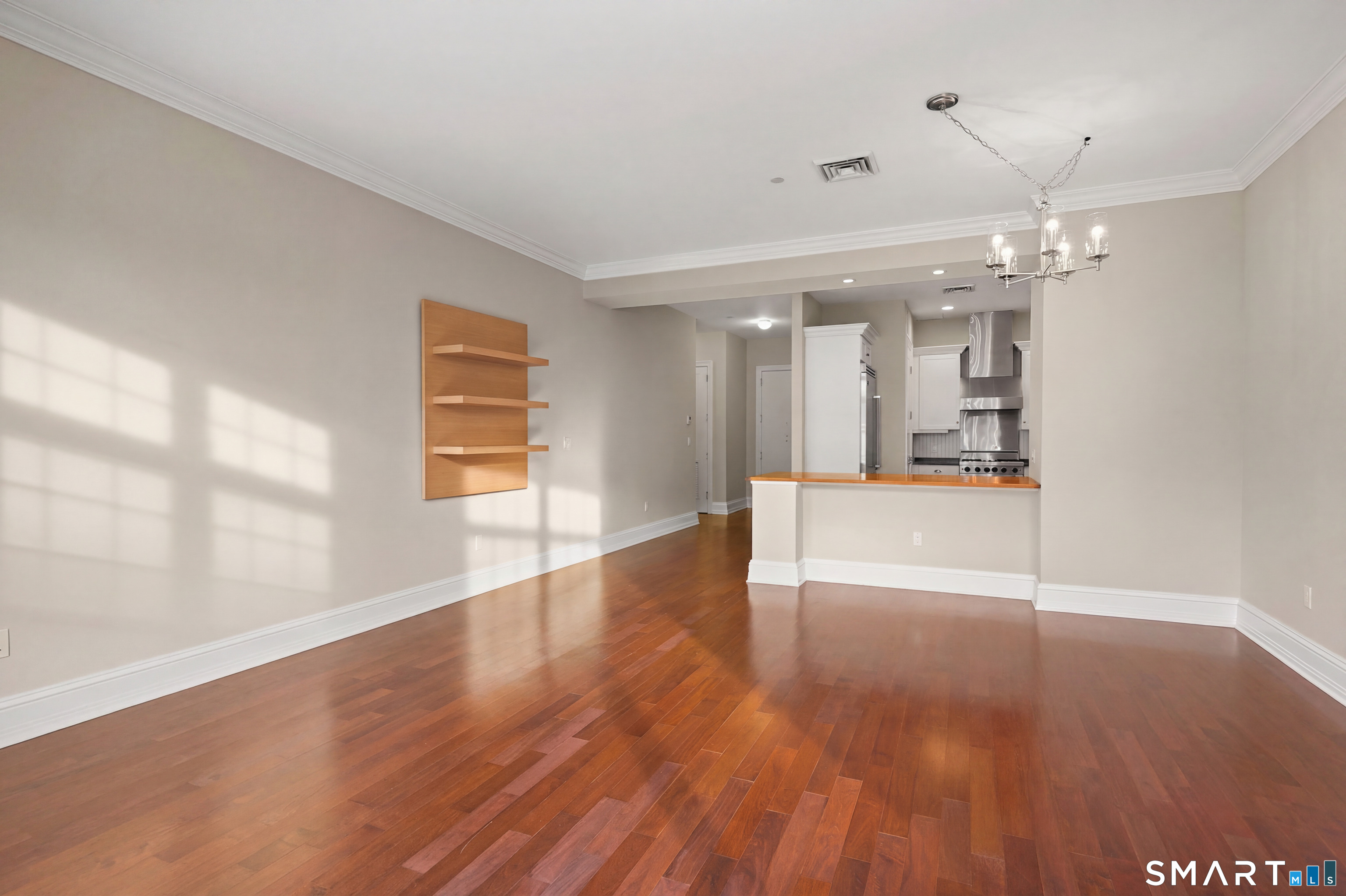 50 Stone Ridge Way, Unit 2A Fairfield, CT 06824 - Photo 4 of 36 a view of an empty room with wooden floor and a window