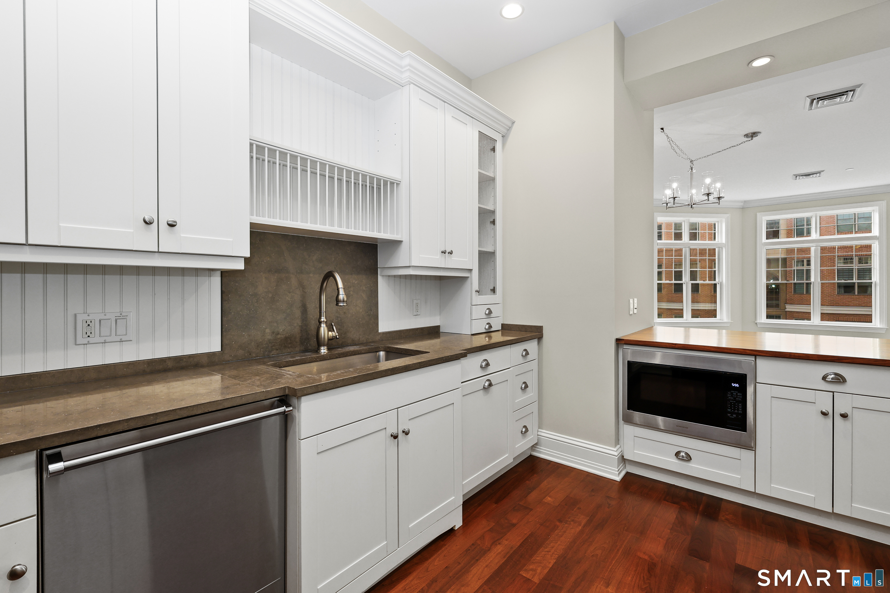 50 Stone Ridge Way, Unit 2A Fairfield, CT 06824 - Photo 9 of 36 a kitchen with granite countertop white cabinets and white appliances