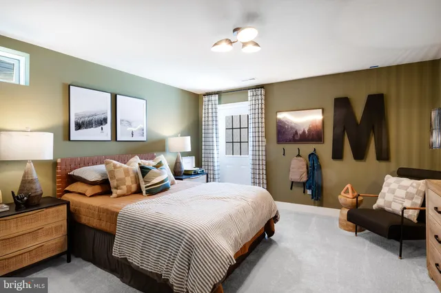 a bedroom with bed and a flat tv screen on dresser