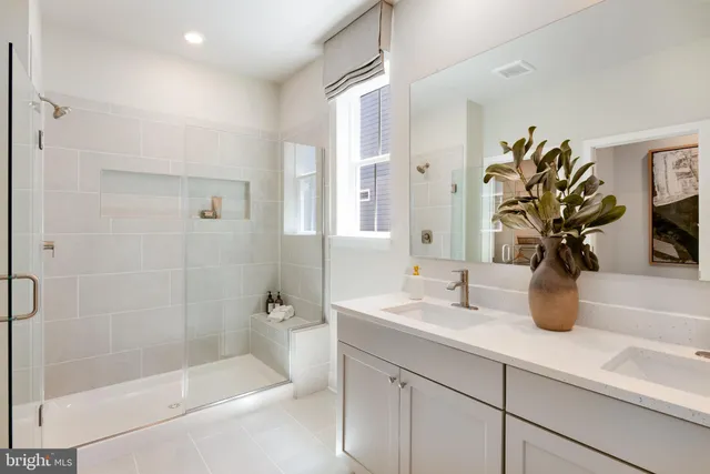 a bathroom with a shower a sink and a mirror