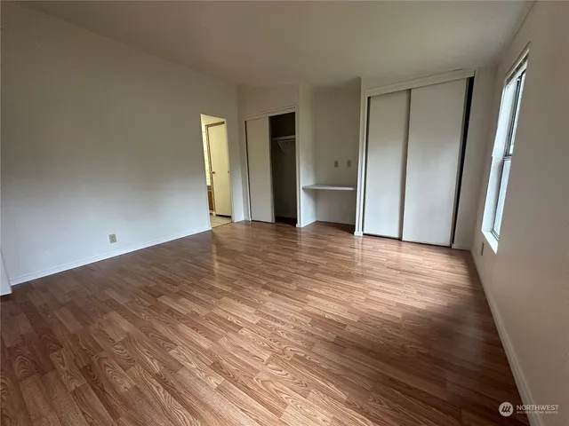 a view of a livingroom with wooden floor and closet