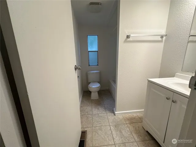 a utility room with cabinets washer and dryer