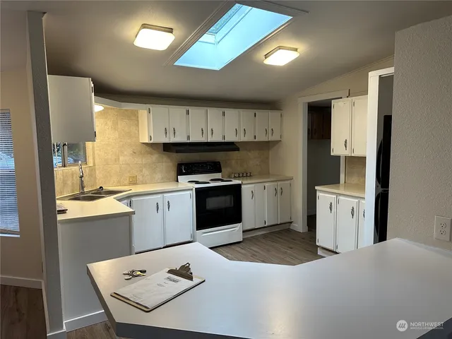 a kitchen with a white cabinets and white appliances