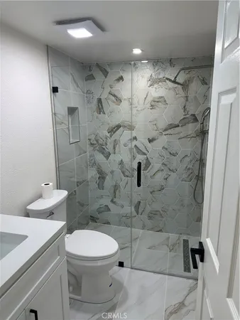 a bathroom with a toilet sink and shower
