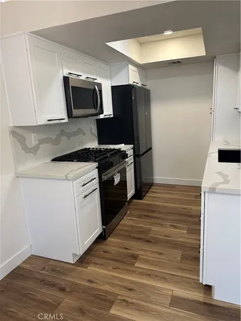 a kitchen with a stove microwave and refrigerator